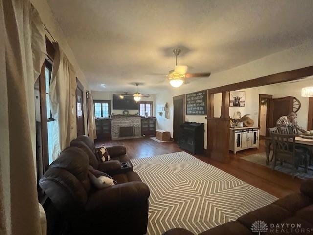 63 N Main St, West Alexandria, OH 45381 - living area with dark wood finished floors, a fireplace, and ceiling fan