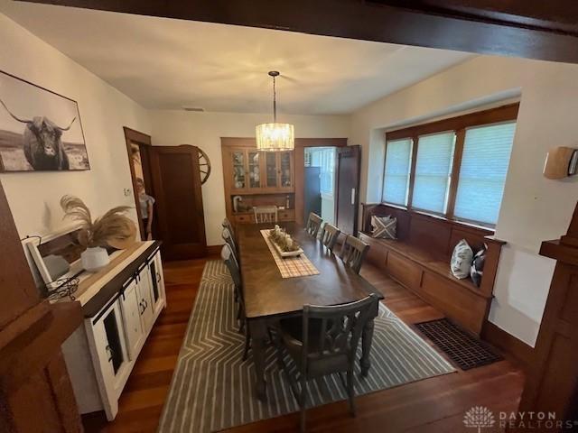 63 N Main St, West Alexandria, OH 45381 - dining space with dark wood-style flooring and a chandelier