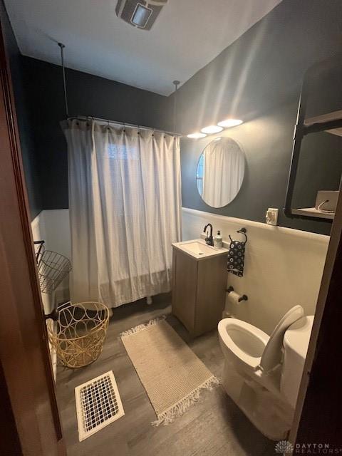 63 N Main St, West Alexandria, OH 45381 - full bathroom featuring shower / tub combo, vanity, and wood finished floors