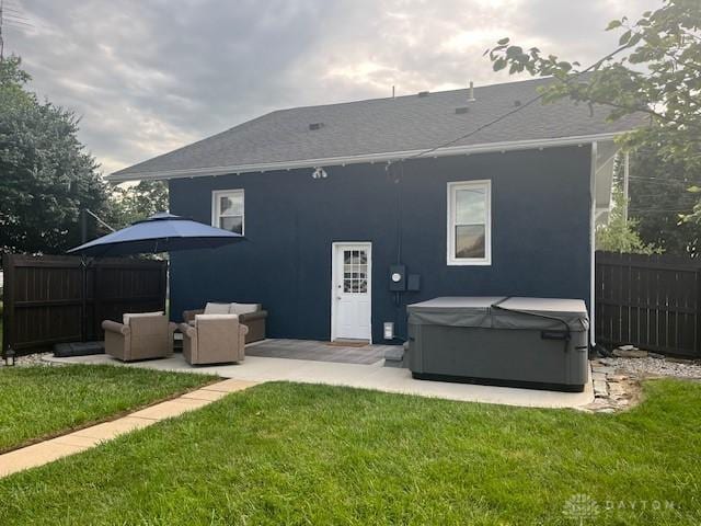 63 N Main St, West Alexandria, OH 45381 - back of house featuring a hot tub, a patio, stucco siding, and an outdoor living space
