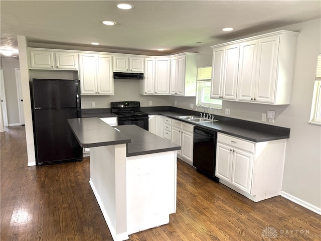 6686 Catskill Dr, Franklin, OH 45005 - kitchen featuring black appliances, dark countertops, under cabinet range hood, white cabinets, and dark wood finished floors