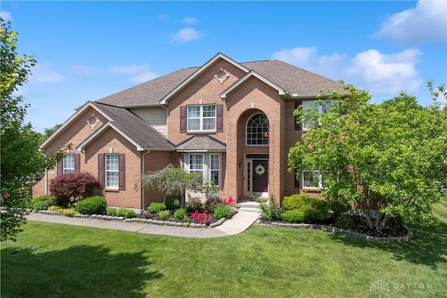 5535 Longhunter Chase Dr, Liberty Twp, OH 45044 - traditional-style home featuring brick siding, a front lawn, and roof with shingles