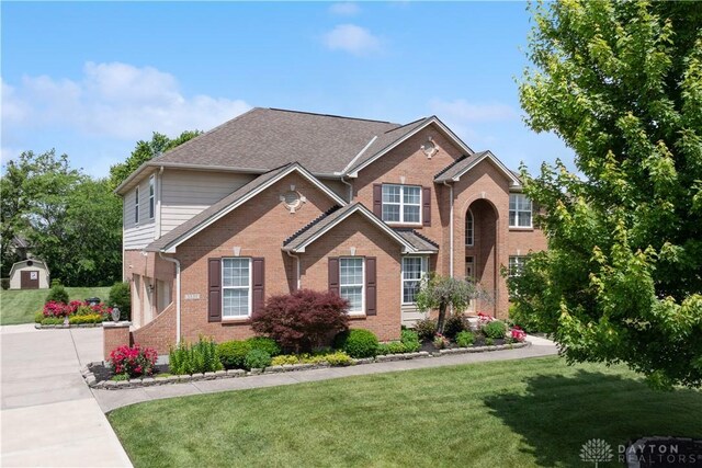 5535 Longhunter Chase Dr, Liberty Twp, OH 45044 - traditional home with brick siding, a garage, a front yard, and concrete driveway