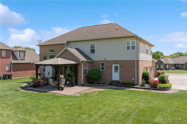 5535 Longhunter Chase Dr, Liberty Twp, OH 45044 - rear view of property with entry steps, a gazebo, brick siding, and a lawn