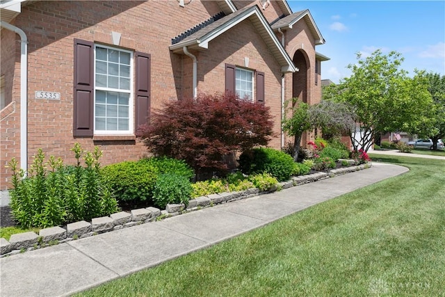 5535 Longhunter Chase Dr, Liberty Twp, OH 45044 - view of home's exterior with a yard and brick siding