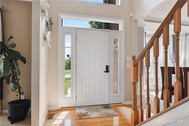 5535 Longhunter Chase Dr, Liberty Twp, OH 45044 - foyer entrance with healthy amount of natural light, light wood finished floors, and stairs
