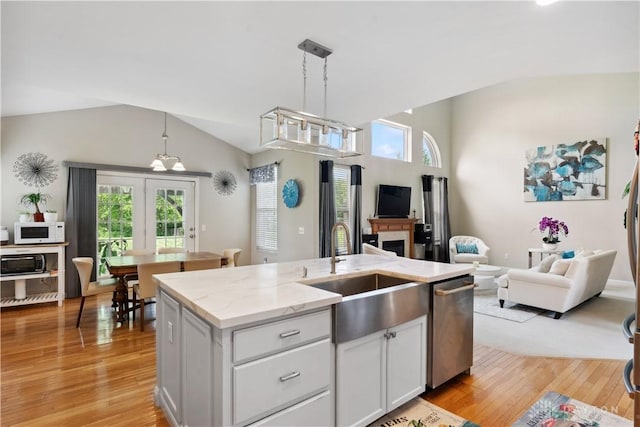5535 Longhunter Chase Dr, Liberty Twp, OH 45044 - kitchen with vaulted ceiling, appliances with stainless steel finishes, open floor plan, light wood-style flooring, and light stone counters