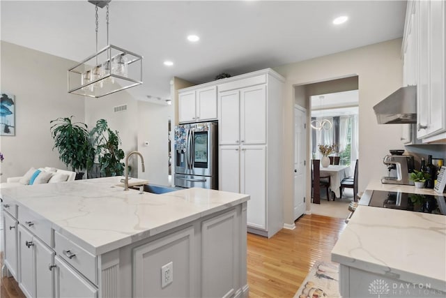 5535 Longhunter Chase Dr, Liberty Twp, OH 45044 - kitchen with stainless steel fridge with ice dispenser, wall chimney exhaust hood, white cabinets, light wood-type flooring, and recessed lighting