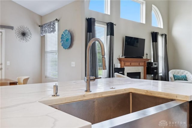 5535 Longhunter Chase Dr, Liberty Twp, OH 45044 - kitchen featuring light stone countertops, a fireplace, and open floor plan