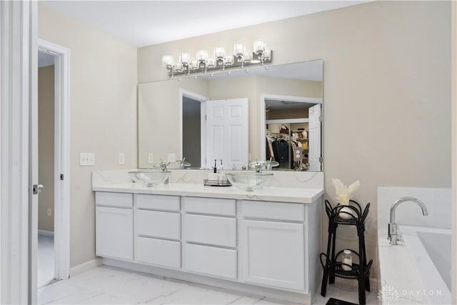 5535 Longhunter Chase Dr, Liberty Twp, OH 45044 - bathroom featuring double vanity, a tub to relax in, and marble finish floors