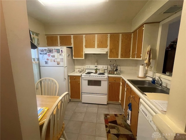 4512 Bonita Dr Unit 118, Middletown, OH 45044 - kitchen with white appliances, under cabinet range hood, light countertops, light tile patterned floors, and brown cabinets
