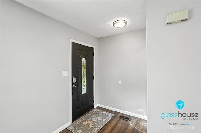 1937 Wilene Dr, Beavercreek, OH 45432 - entrance foyer with dark wood-style floors and a textured ceiling