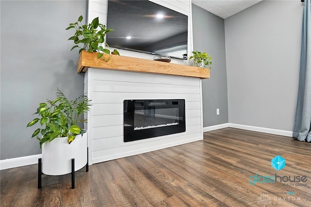 1937 Wilene Dr, Beavercreek, OH 45432 - unfurnished living room with wood finished floors and a glass covered fireplace