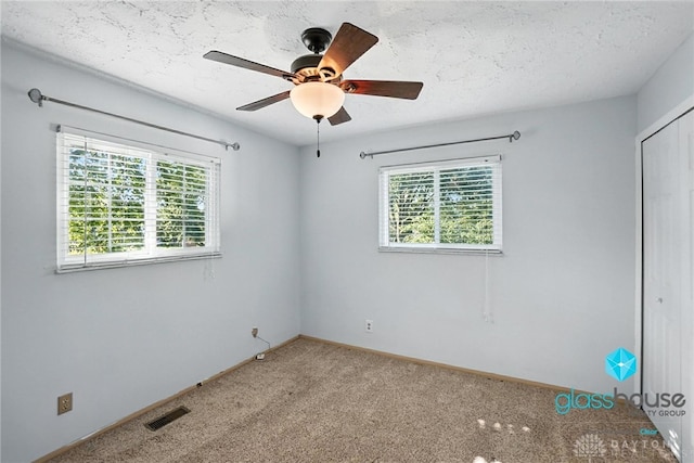1937 Wilene Dr, Beavercreek, OH 45432 - unfurnished bedroom with multiple windows, light colored carpet, a closet, ceiling fan, and a textured ceiling
