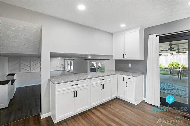 1937 Wilene Dr, Beavercreek, OH 45432 - kitchen featuring dark wood finished floors, light stone countertops, white cabinetry, healthy amount of natural light, and recessed lighting