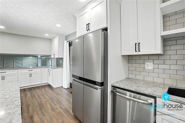 1937 Wilene Dr, Beavercreek, OH 45432 - kitchen with stainless steel appliances, white cabinets, dark wood-style floors, tasteful backsplash, and a textured ceiling