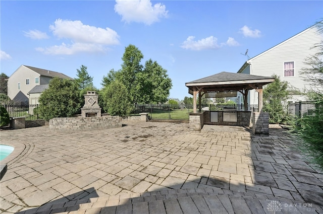 4300 Turtledove Way, Miamisburg, OH 45342 - fenced backyard featuring a gazebo, exterior fireplace, a patio, and area for grilling