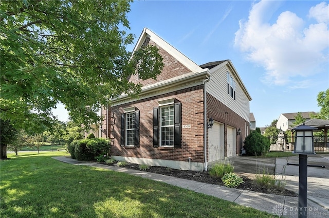 4300 Turtledove Way, Miamisburg, OH 45342 - view of property exterior with brick siding, a garage, and driveway