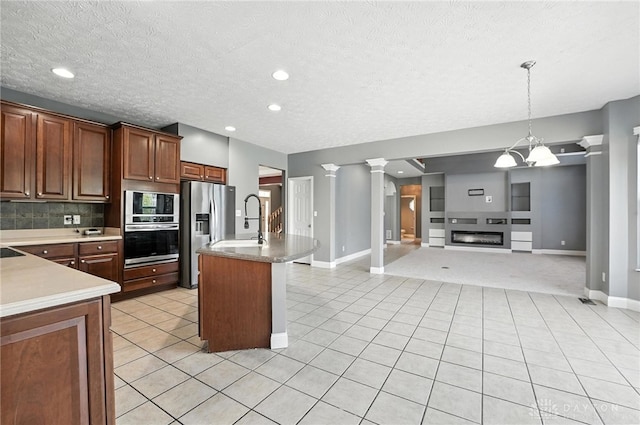 4300 Turtledove Way, Miamisburg, OH 45342 - kitchen with appliances with stainless steel finishes, open floor plan, ornate columns, light tile patterned floors, and recessed lighting