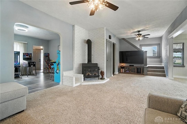 1551 W Main St, New Lebanon, OH 45345 - carpeted living area with a ceiling fan, a wood stove, and plenty of natural light
