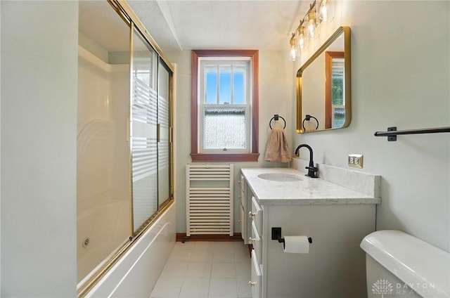 1551 W Main St, New Lebanon, OH 45345 - bathroom featuring radiator, vanity, shower / bath combination with glass door, and tile patterned flooring