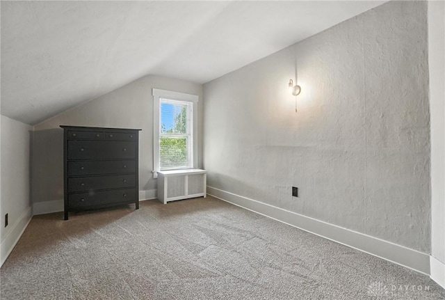 1551 W Main St, New Lebanon, OH 45345 - bonus room featuring radiator heating unit, lofted ceiling, and carpet flooring