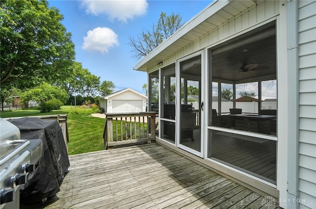 1551 W Main St, New Lebanon, OH 45345 - wooden deck featuring an outbuilding, a sunroom, a lawn, and area for grilling
