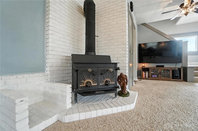 1551 W Main St, New Lebanon, OH 45345 - detailed view of carpet, a wood stove, and a ceiling fan