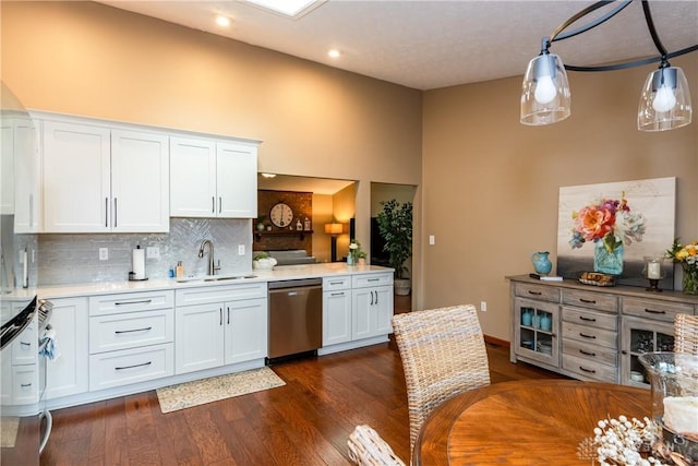 100 Timberwind Ln, Vandalia, OH 45377 - kitchen with stainless steel appliances, backsplash, white cabinetry, light countertops, and dark wood-type flooring