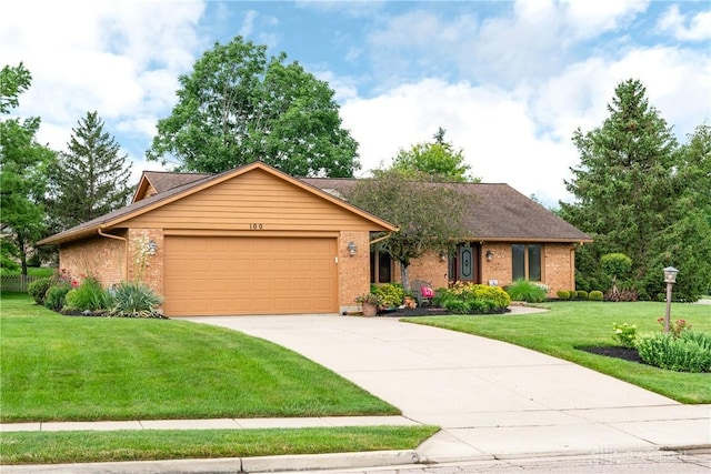 100 Timberwind Ln, Vandalia, OH 45377 - ranch-style house featuring an attached garage, brick siding, concrete driveway, and a front yard