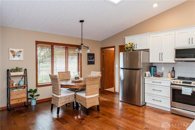 100 Timberwind Ln, Vandalia, OH 45377 - dining space featuring vaulted ceiling, dark wood-style floors, and recessed lighting