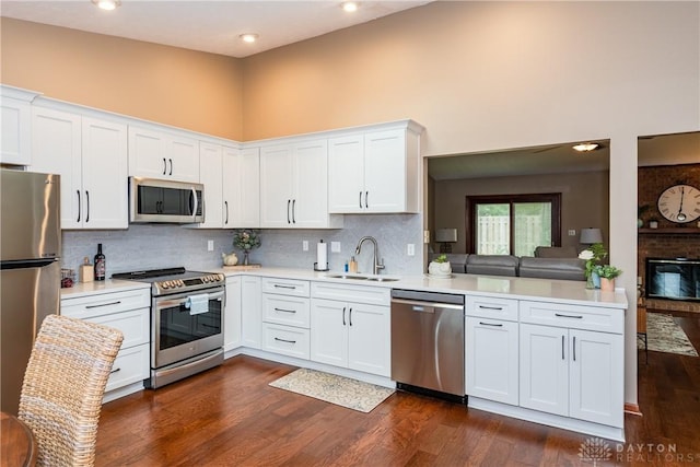 100 Timberwind Ln, Vandalia, OH 45377 - kitchen with stainless steel appliances, light countertops, white cabinets, backsplash, and dark wood-type flooring