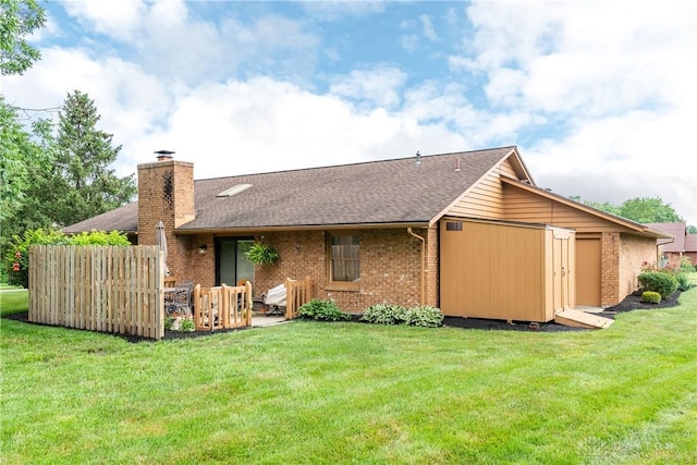 100 Timberwind Ln, Vandalia, OH 45377 - rear view of property featuring brick siding, a chimney, roof with shingles, and a patio area