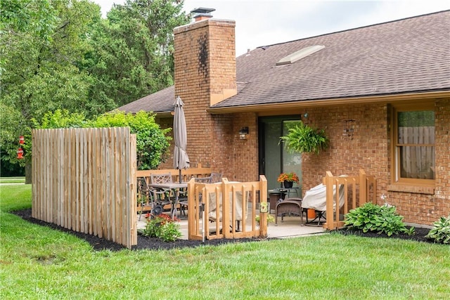 100 Timberwind Ln, Vandalia, OH 45377 - rear view of property with roof with shingles, a patio, brick siding, and a chimney