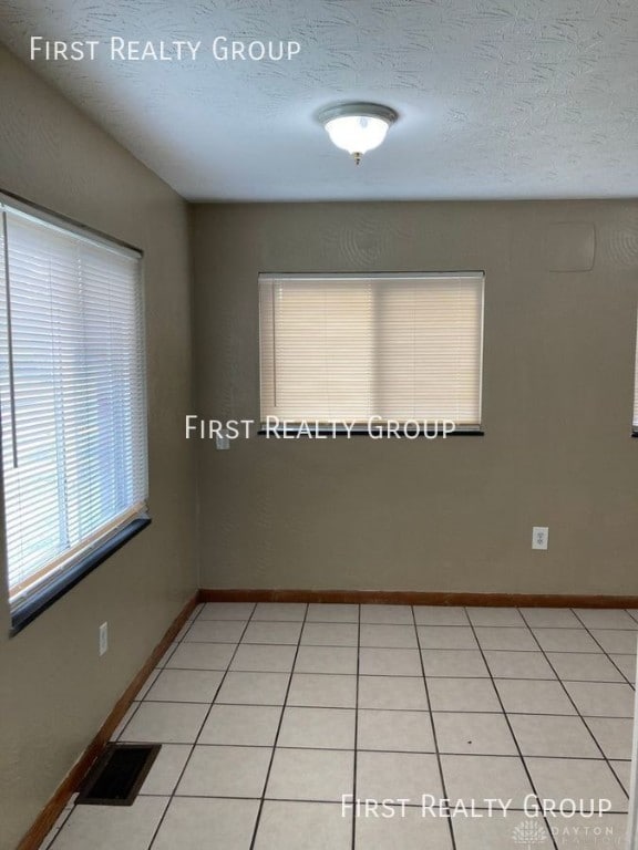 2011 Riverside Dr, Dayton, OH 45405 - unfurnished room featuring light tile patterned floors and a textured ceiling