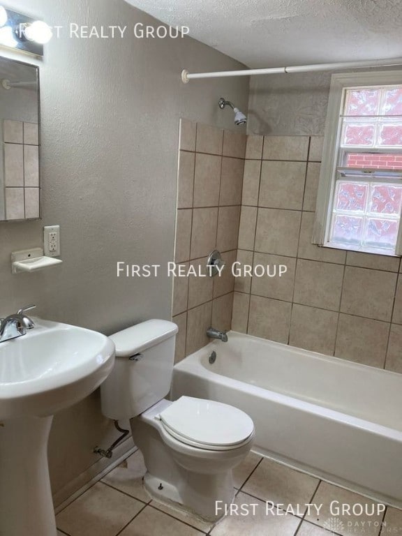 2011 Riverside Dr, Dayton, OH 45405 - full bathroom with tile patterned floors, shower / tub combination, and a textured ceiling