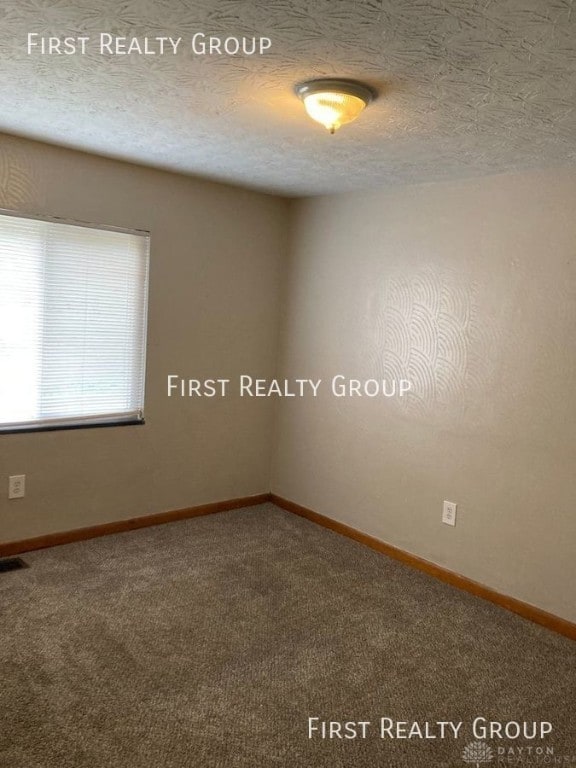 2011 Riverside Dr, Dayton, OH 45405 - empty room featuring carpet and a textured ceiling