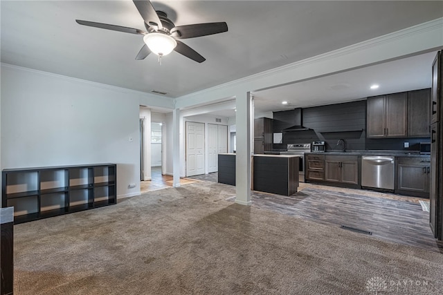 359 Gladys Ave, Franklin, OH 45005 - kitchen with stainless steel appliances, crown molding, wall chimney range hood, ceiling fan, and light carpet