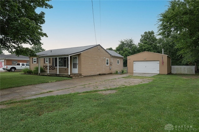 359 Gladys Ave, Franklin, OH 45005 - view of front of property with an outbuilding, a front yard, a detached garage, and a metal roof