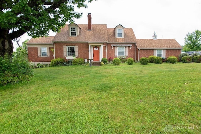 557 W N Bend Rd, Springfield Twp, OH 45224 - cape cod house with brick siding, a chimney, a front lawn, and roof with shingles