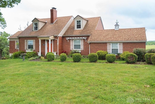 557 W N Bend Rd, Springfield Twp, OH 45224 - new england style home featuring brick siding, a front lawn, a chimney, and roof with shingles