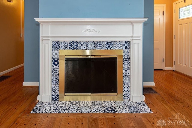 557 W N Bend Rd, Springfield Twp, OH 45224 - detailed view of wood finished floors and a tile fireplace