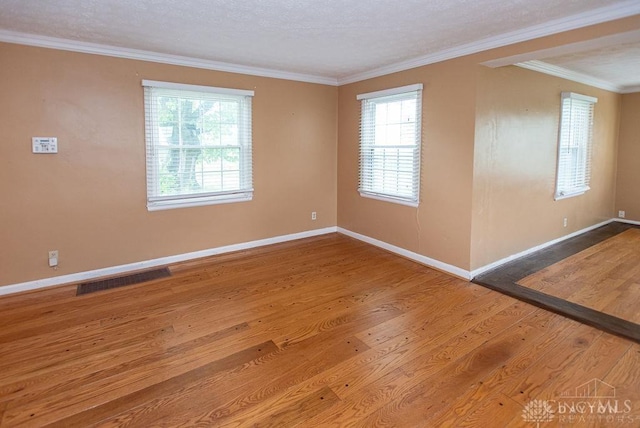 557 W N Bend Rd, Springfield Twp, OH 45224 - unfurnished room with wood finished floors, healthy amount of natural light, and crown molding