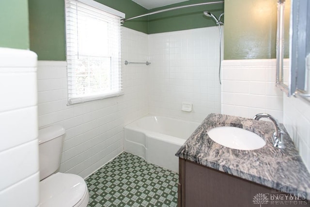 557 W N Bend Rd, Springfield Twp, OH 45224 - full bathroom featuring tile walls, vanity, shower / bathtub combination, a wainscoted wall, and tile patterned floors