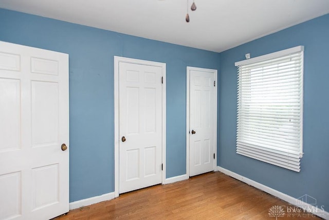 557 W N Bend Rd, Springfield Twp, OH 45224 - unfurnished bedroom featuring wood finished floors and baseboards