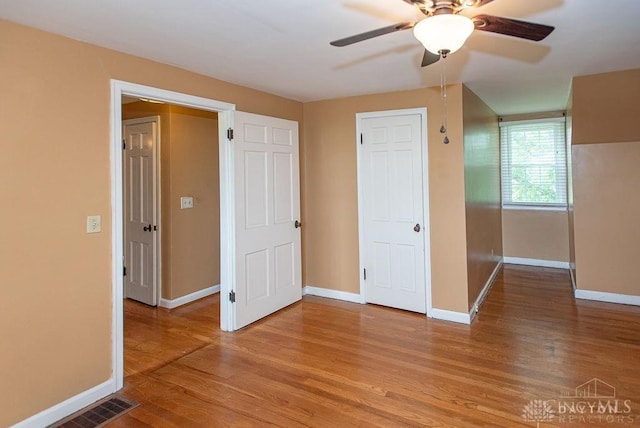 557 W N Bend Rd, Springfield Twp, OH 45224 - unfurnished bedroom featuring light wood-style floors and ceiling fan