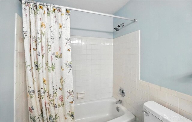 2184 Broadbent Way, Dayton, OH 45440 - bathroom featuring shower / bath combo and tile walls