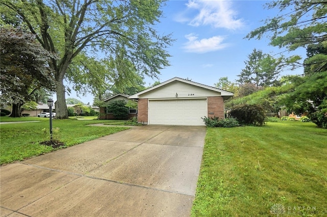 2184 Broadbent Way, Dayton, OH 45440 - view of property exterior with a garage, a yard, brick siding, and concrete driveway