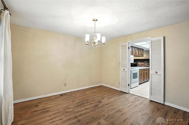 2184 Broadbent Way, Dayton, OH 45440 - unfurnished dining area featuring a chandelier and wood finished floors