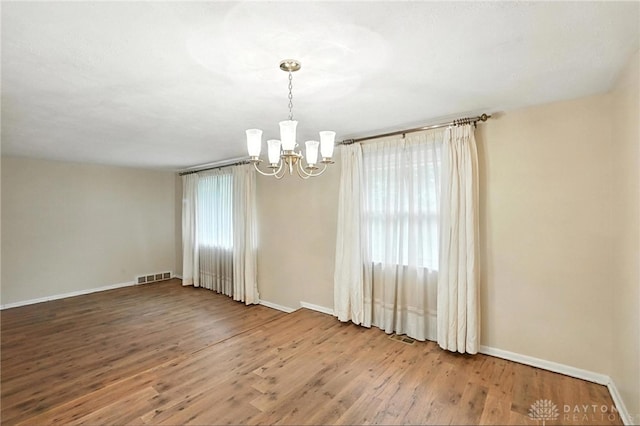 2184 Broadbent Way, Dayton, OH 45440 - unfurnished room featuring a chandelier, wood finished floors, and healthy amount of natural light